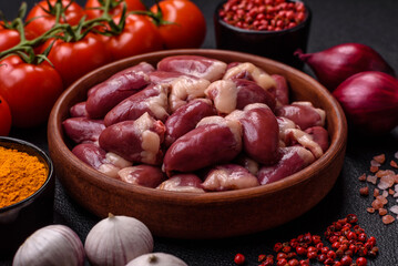 Raw chicken hearts with salt, spices and herbs