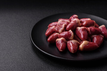 Raw chicken hearts with salt, spices and herbs