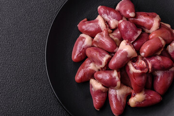 Raw chicken hearts with salt, spices and herbs