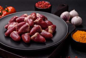 Raw chicken hearts with salt, spices and herbs
