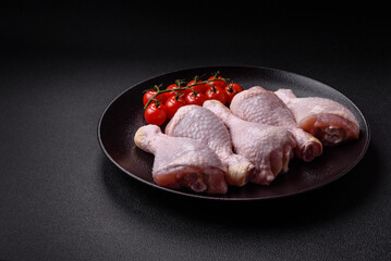 Raw chicken legs with salt, spices and herbs