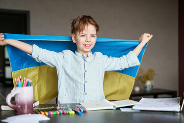 Little boy smiling holding a yellow and blue flag Ukraine. Ukrainian child. Independence Day of...