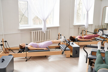 Two sporty women exercising in a serene room.