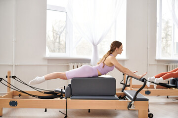 Fit woman exercising during a pilates lesson.