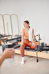 Fototapeta premium Sporty women spending time together on pilates lesson in gym, relaxing.