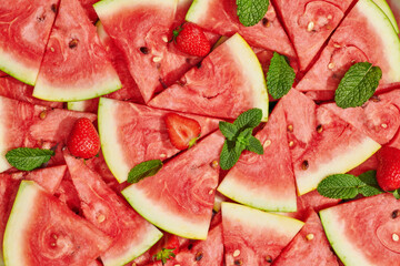 heap of fresh sliced watermelon with strawberries