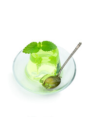 Green jelly on glass saucer isolated on white