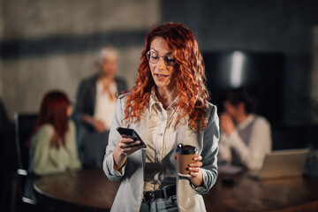 Female manager contacting clients on a phone on meeting at boardroom.