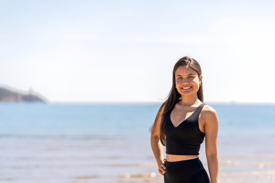 Smiling Pilates Instructor by the Beach - Powered by Adobe