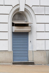 Closed metal front door of store outside on a street