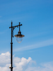 metal black retro lantern on blue sky background