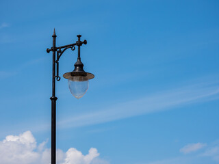 metal black retro lantern on blue sky background