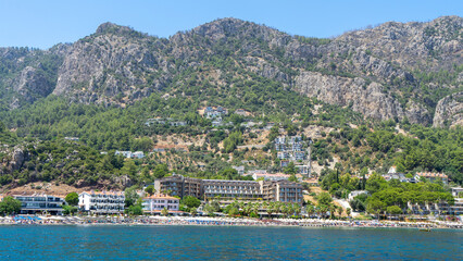 Obraz premium Village Turunс, neighbourhood of municipality and district Marmaris, Mugla Province, Turkey. Holiday resort on Mediterranean Sea coast. Taurus Mountains