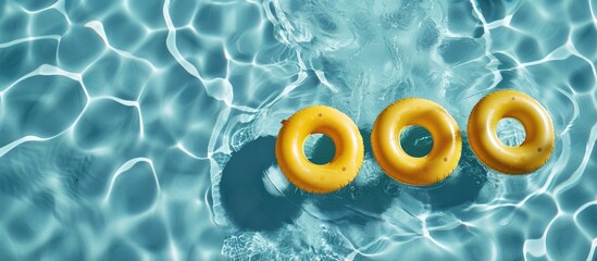 Three yellow pool rings floating in a swimming pool, with space for your text