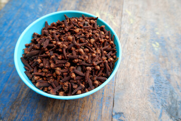 dried cloves in a bowl. Syzygium aromaticum. copy space