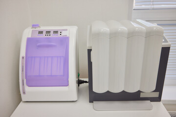 Modern Office White and Purple Pneumatic Foot Massager on Desk Next to Windowsill