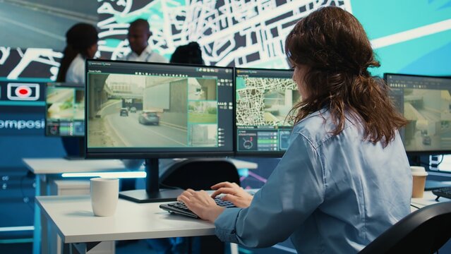 Diverse team of employees monitoring delivery trucks routes around the city with map and surveillance footage. People working with gps coordinates for tracking orders, cargo logistics. Camera B.