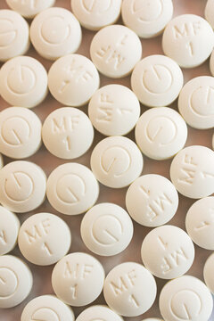 Generic metformin dispensed from a pharmacy 500 mg tablets on a white background.   Top down view.