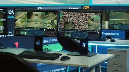 Empty agency office works on traffic surveillance with CCTV security system, public safety...