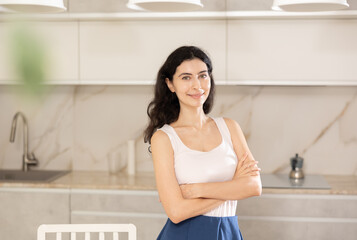 Portrait of housewife standing at home kitchen