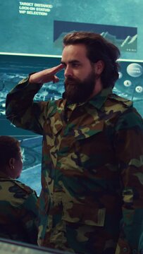 Vertical Video Sergeant presenting his salute with respect for the colonel and high ranking military officers, saluting the captains while he works on intelligence in command center, pride and duty