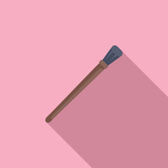 Makeup brush lying diagonally on pink background casting a long shadow