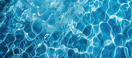 Abstract overhead view of empty swimming pool with crystal clear water surface and blue underwater pattern, devoid of any swimmers.