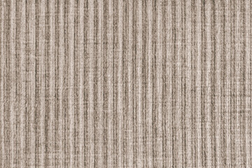 Ridge texture background of velour corduroy brown cloth. Large ribbed, coarse weaving velveteen,...