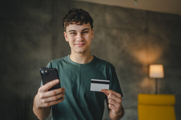 teenager young man at home use credit card shopping online e-banking