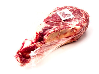 Premium tomahawk steak in vacuum package with security tag. Top quality beef meat product protection from criminal act of theft and stealing. White background.