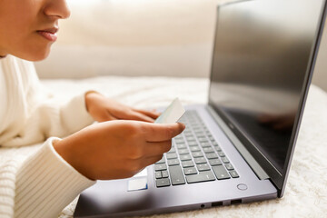 women Conducting Financial Transactions Online in the bed. Copyspace