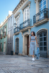 Young Woman in Grey Dress on Marble Street in Almeria