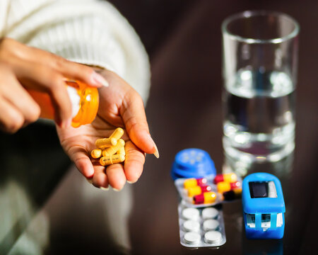 Woman Holding a Pill and Preparing to Take It.copyspace