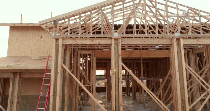 Wooden frame of apartment building under construction in new developing suburban area. Development of residential housing in Florida suburbs. Real estate market in the USA.