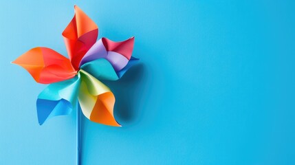 Vibrant pinwheel on a blue backdrop with space for text