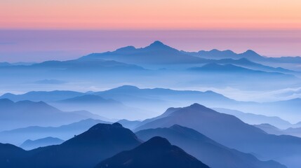 Fototapeta premium beauty of mountain ranges layered in shades of blue and purple, basked in the warm glow of sunrise