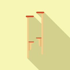 Two wooden stilts are standing upright, ready for someone to use them for fun and entertainment