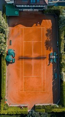 Summer tennis court with orange clay surface and green surroundings, perfect for stock images