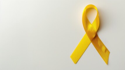 Yellow awareness ribbon on white background symbolizing support or