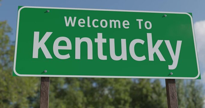 Driving By A Welcome To Kentucky Green Road Sign Against a Blue Sky and Clouds.
