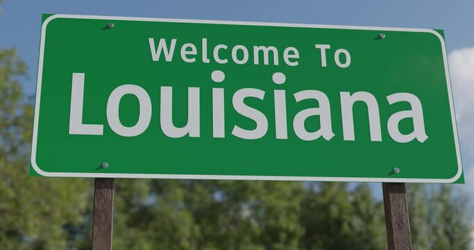 Driving By A Welcome To Louisiana Green Road Sign Against a Blue Sky and Clouds.
