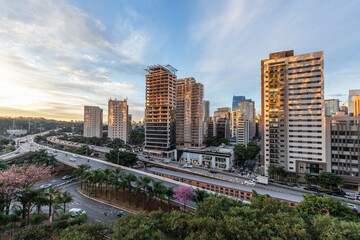 View of sunset  in Sao Paulo city, Brazil. Beggining the night in metropolis, Skyline, cars and traffic on the road