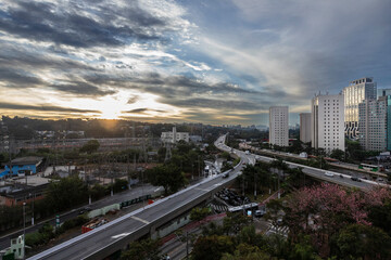 Fototapeta premium View of sunset in Sao Paulo city, Brazil. Beggining the night in metropolis, Skyline, cars and traffic on the road
