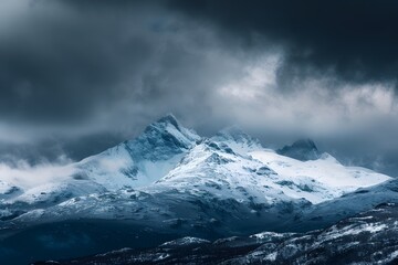 Snow-Capped Peaks Under a Stormy Sky