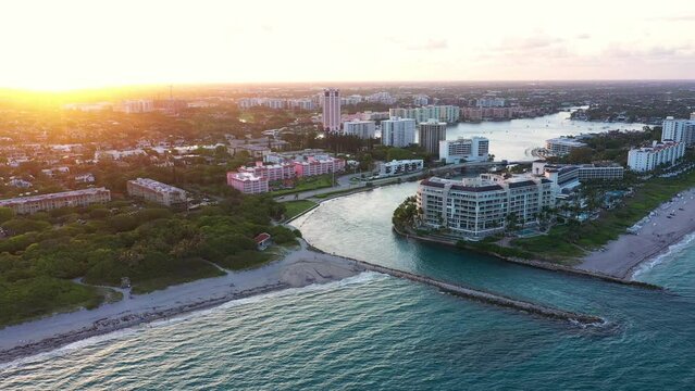 Cinematic aerial view of Boca Raton , Florida lake and inlet at sunset. 