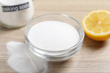 Baking soda and lemon on wooden table