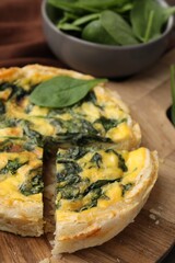 Delicious pie with spinach on table, closeup