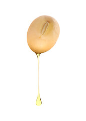 Cooking oil dripping from soybean on white background