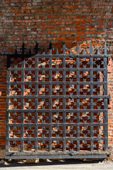 An old wrought iron gate on the background of a brick wall in the ancient Kremlin in Nizhny Novgorod