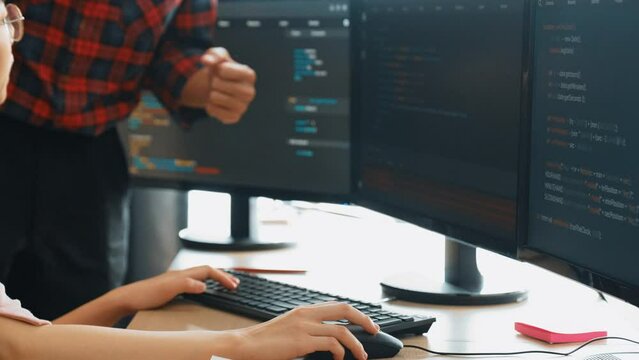 Slow motion back end or software developer manager supervising his team on new application program development on debugging and solving complex code algorithms on monitor. Burgeoning